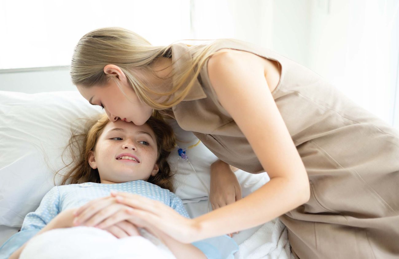 Psychosomatische Bauchschmerzen bei Kindern: Mutter tröstet Tochter