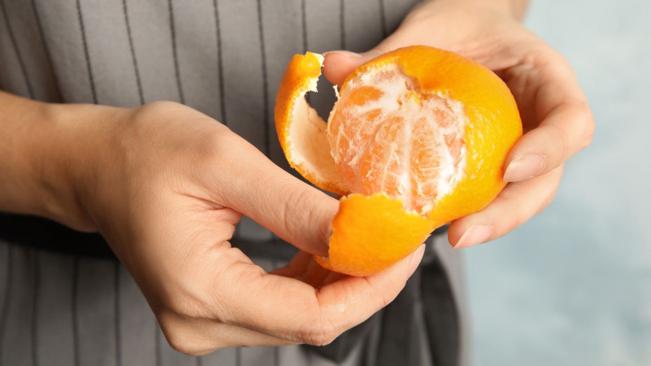 Mandarinen-Allergie, Mann schält Mandarine